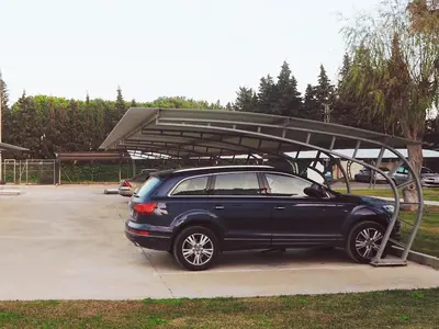 a car parked in a parking lot with a canopy at Apartamento La Barrosa, Chiclana in Chiclana de la Frontera