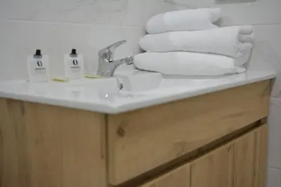 a bathroom sink with towels on top of it at Apartamentos Turísticos La Terraza* in Las Cabezas de San Juan