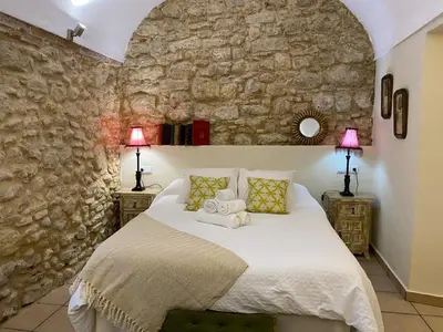 a bedroom with a bed with two towels on it at Casa Arco de la Pastora in Medina Sidonia