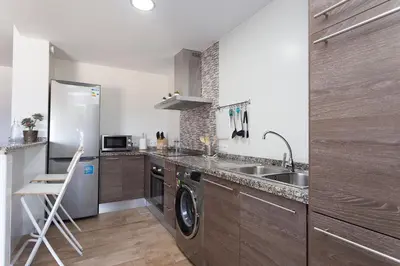 a kitchen with a sink and a dishwasher at APARTAMENTO VIRGEN DEL CARMEN in Chipiona