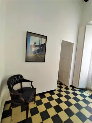 a chair sitting in a room with a checkered floor at Sol de Cádiz in Cádiz