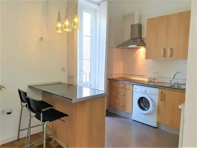 a kitchen with a sink and a washing machine at Sol de Cádiz in Cádiz