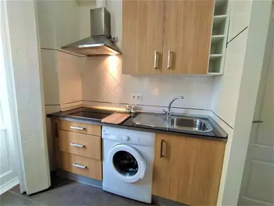 a kitchen with a washing machine and a sink at Sol de Cádiz in Cádiz