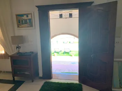 a living room with a window with white curtains at La Quinta - La Barrosa in Chiclana de la Frontera