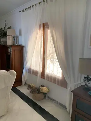 a living room with a table and a fireplace at La Quinta - La Barrosa in Chiclana de la Frontera