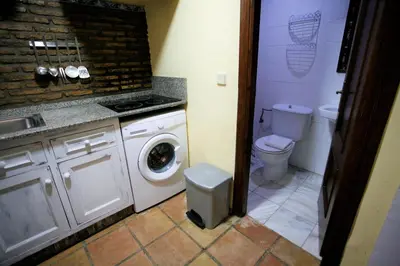 a bathroom with a washing machine and a toilet at Duplex 6 pax con Wifi en Bahia Sur con parking y piscinas comunitarias in San Fernando