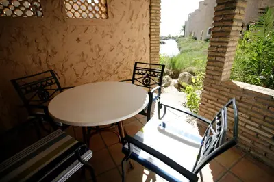 a table and chairs on a balcony with a window at Duplex 6 pax con Wifi en Bahia Sur con parking y piscinas comunitarias in San Fernando