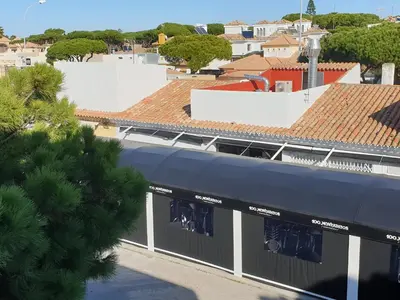 a building with a blue awning in a city at Pinar de Don Jesus Sagitario in Campano