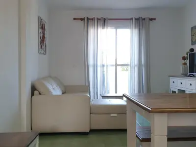 a living room with a white couch and a window at Pinar de Don Jesus Sagitario in Campano