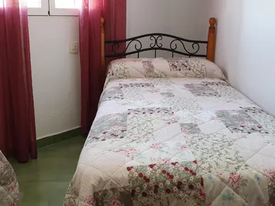 a bed with a quilt on it in a bedroom at Pinar de Don Jesus Sagitario in Campano