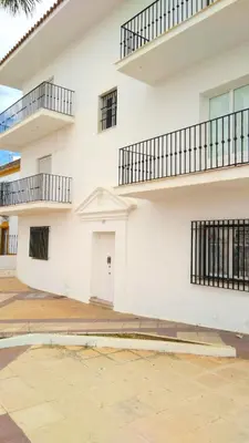 a white building with balconies on the side of it at Magnífico alojamiento a 3 metros de la playa y en la Plaza del Castillo in Chipiona