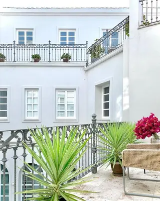 a white house with plants in front of it at Hotel Boutique Palacio Corredera in Jerez de la Frontera