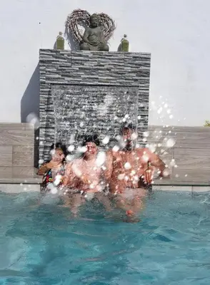 a group of people in the water in a swimming pool at Mint House in Chiclana de la Frontera