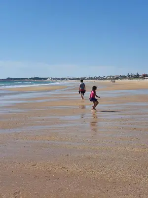 a couple of people walking on the beach at Mint House in Chiclana de la Frontera