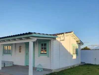 a small white house with a pitched roof at Mint House in Chiclana de la Frontera