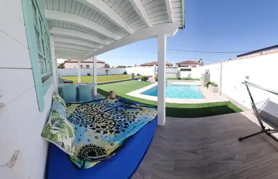 a balcony with a bed and a swimming pool at Mint House in Chiclana de la Frontera