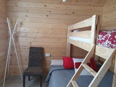 a bedroom with a bunk bed and a chair at Mint House in Chiclana de la Frontera