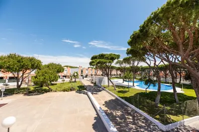 a view of a park with trees and a pool at Apartamento Playa La Barrosa in Chiclana de la Frontera