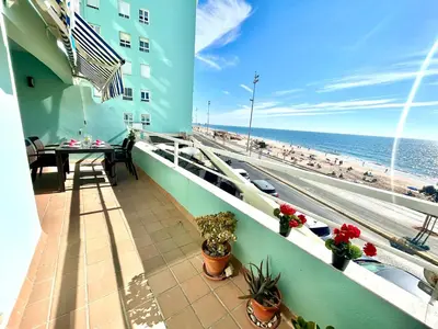 a balcony with a view of the beach and the ocean at GATU PREMIUM Villa Isabel TERRAZA,PARKING,1ºLINEA PLAYA,WIFI,VISTA AL MAR in Cádiz