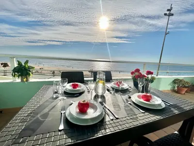 a table with food and a view of the beach at GATU PREMIUM Villa Isabel TERRAZA,PARKING,1ºLINEA PLAYA,WIFI,VISTA AL MAR in Cádiz