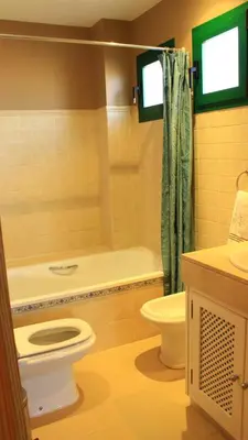 a bathroom with a toilet and a tub and a sink at El Anfitrión - Mirador de los Navegantes in Sanlúcar de Barrameda