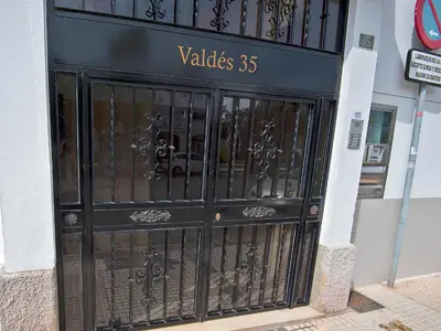 a large black door with a sign on it at Plaza de Toros 3-Bedroom Apartment with Balcony in El Puerto de Santa María