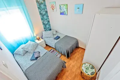 a room with a couch and a bed and a mirror at Plaza de Toros 3-Bedroom Apartment with Balcony in El Puerto de Santa María