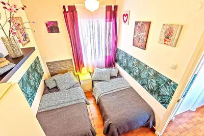 a bedroom with two beds in a room at Plaza de Toros 3-Bedroom Apartment with Balcony in El Puerto de Santa María