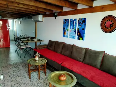 a living room with a red couch and tables at Villa casa blanca luxury spa con piscina privada y jacuzzi privado in Chiclana de la Frontera