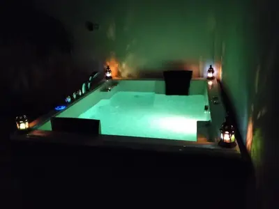 a swimming pool in a dark room with lights at Villa casa blanca luxury spa con piscina privada y jacuzzi privado in Chiclana de la Frontera
