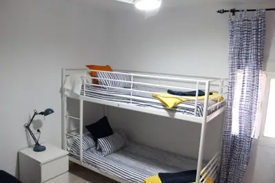 a white shelving unit in a room at Villa andaluza en zona Playa Barrosa con piscina y barbacoa in Chiclana de la Frontera