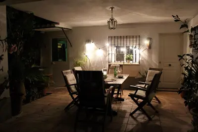 a dining room with a table and chairs at Villa andaluza en zona Playa Barrosa con piscina y barbacoa in Chiclana de la Frontera