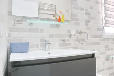 a bathroom with a white sink and a mirror at Chalet Puente Tabla in Conil de la Frontera