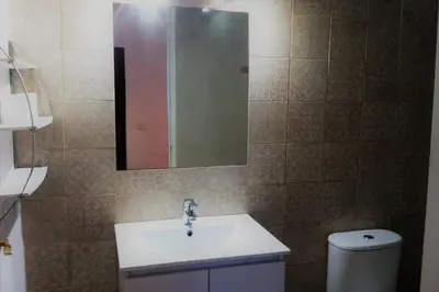 a bathroom with a sink and a mirror and a toilet at Casa Florinda #1 in Jerez de la Frontera