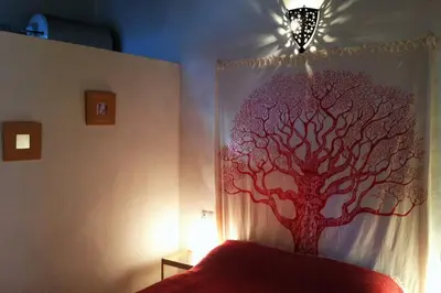 a bedroom with a tree mural on the wall at Casa Florinda #1 in Jerez de la Frontera