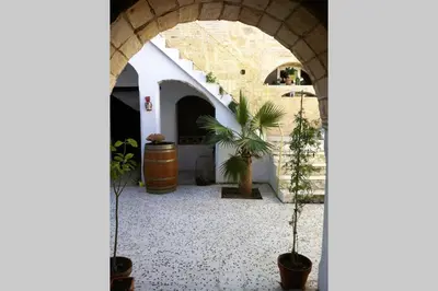 an archway with potted plants in a courtyard at Casa Florinda #1 in Jerez de la Frontera