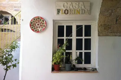 a window of a pizza house with potted plants at Casa Florinda #1 in Jerez de la Frontera