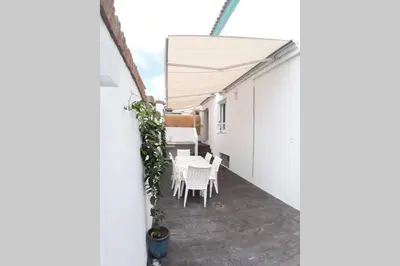 a balcony with a table and chairs in a building at CASA DE DISEÑO EN LA PLAYA. in Rota