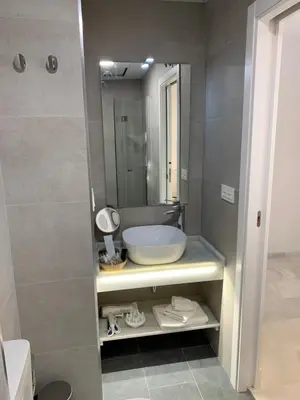 a bathroom with a sink and a mirror at San Lorenzo Apartamentos y Suites in Cádiz