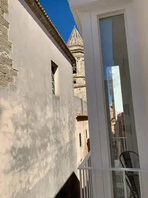 a balcony with a view of a building at San Lorenzo Apartamentos y Suites in Cádiz