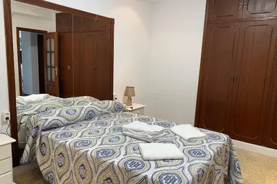 a bedroom with a bed with towels on it at Mirador Playa Caleta Cádiz Centro Grupo AC Gestion in Cádiz