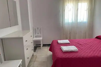 a bedroom with a red bed with two towels on it at Mirador Playa Caleta Cádiz Centro Grupo AC Gestion in Cádiz