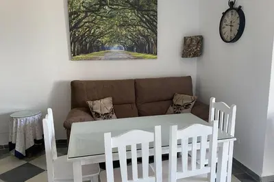 a white table and chairs in a living room with a couch at Mirador Playa Caleta Cádiz Centro Grupo AC Gestion in Cádiz