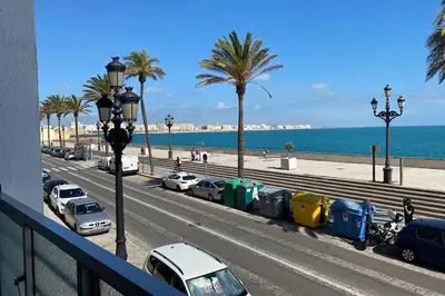 a street with cars parked next to the beach at Mirador Playa Caleta Cádiz Centro Grupo AC Gestion in Cádiz