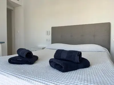 two towels sitting on top of a bed at Plaza Libertad Grupo AC Gestion in Cádiz