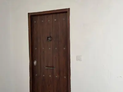 a wooden door in the corner of a room at Plaza Libertad Grupo AC Gestion in Cádiz