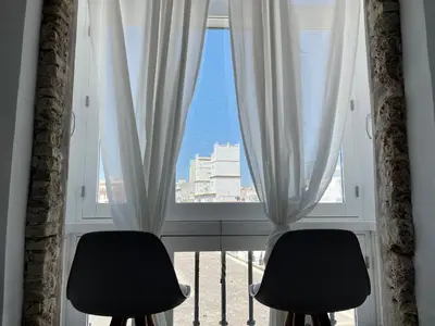 two chairs sitting in front of a window at Plaza Libertad Grupo AC Gestion in Cádiz