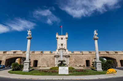 a building with a tower with a flag on it at Apartamento Barrocal by Cadiz Time in Cádiz