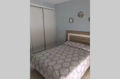 a small bedroom with a bed and a closet at CASA MARINA DE LA BAHIA in Puerto Real