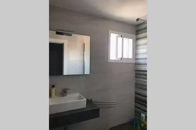 a bathroom with a sink and a mirror at CASA MARINA DE LA BAHIA in Puerto Real